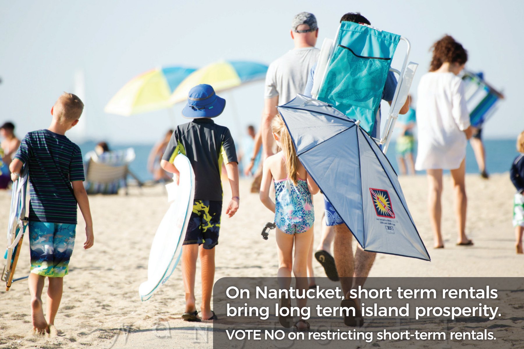 Mailer front: a family carrying beach chairs and umbrellas across the sand, with the headline about short term rentals bringing long term island prosperity.